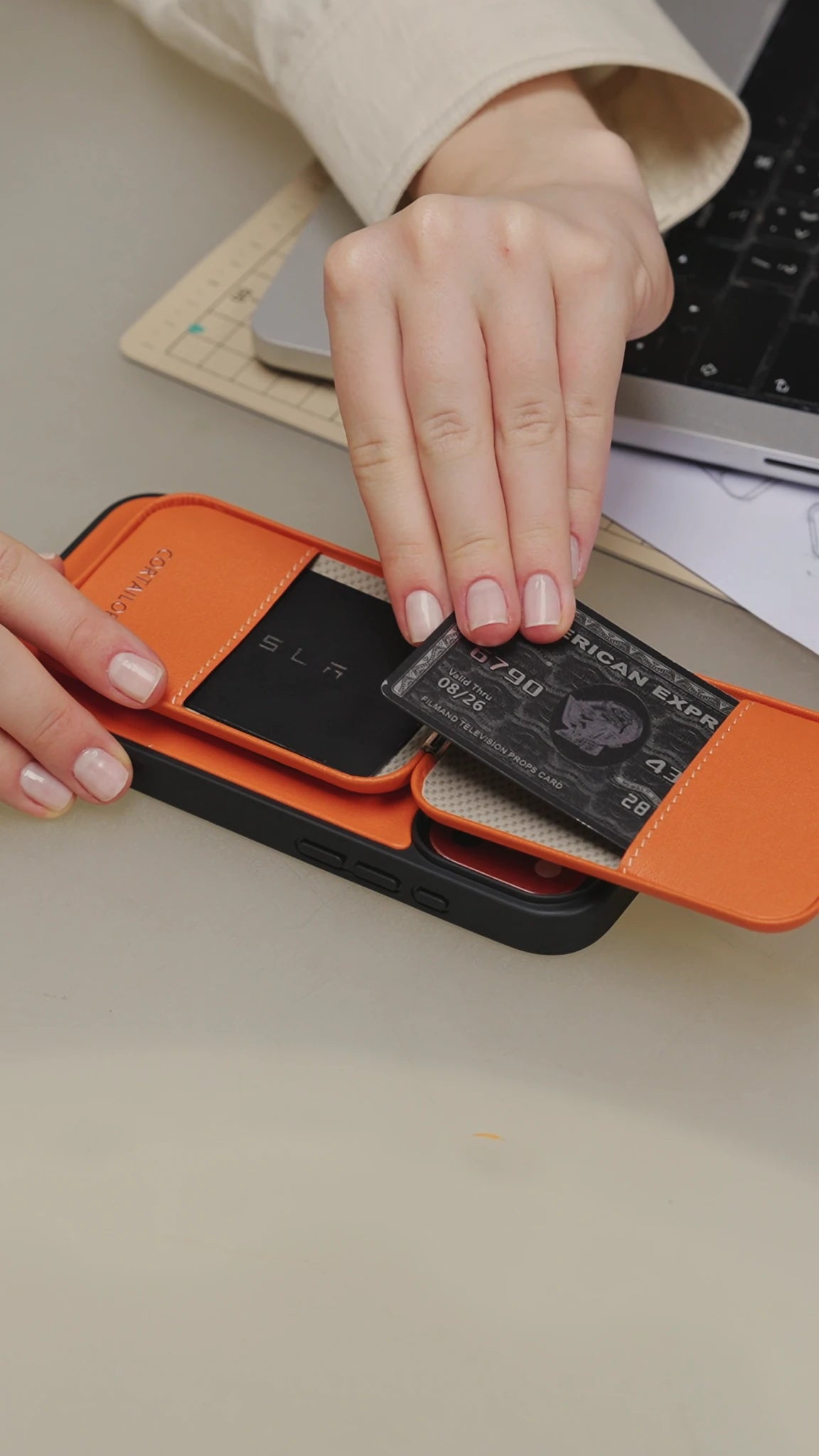 Orange CORTAILOR MagSafe Leather Wallet Stand being placed into a daily carry bag
