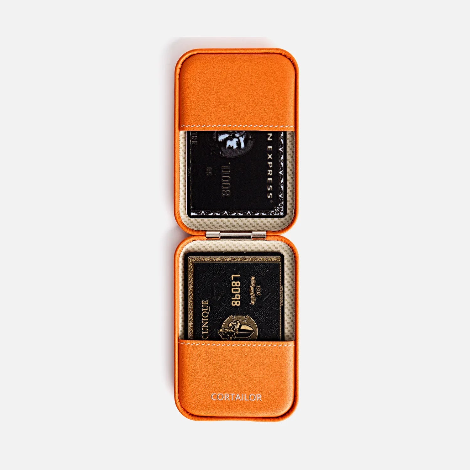 Orange CORTAILOR MagSafe Leather Wallet Stand being placed into a daily carry bag
