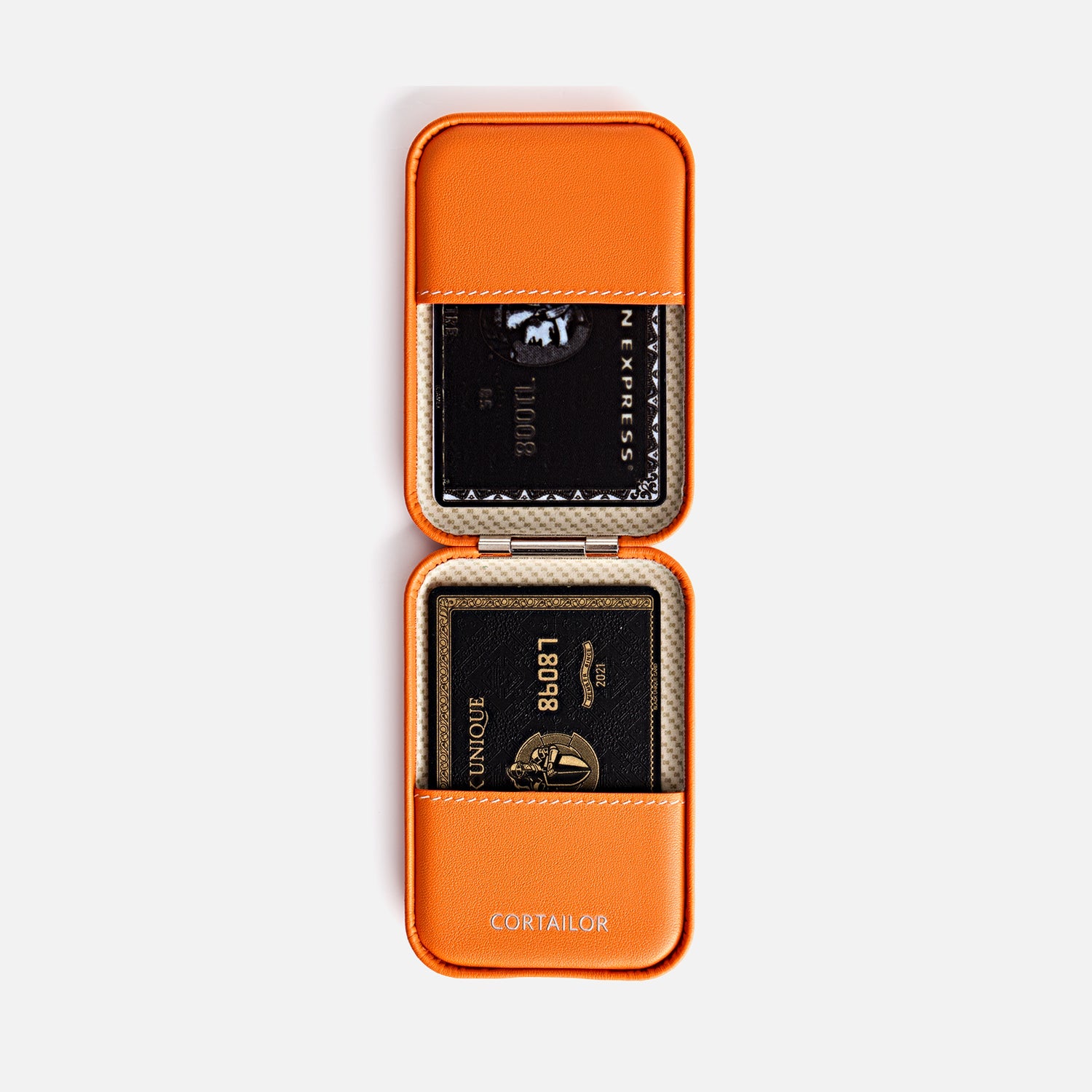 Orange CORTAILOR MagSafe Leather Wallet Stand being placed into a daily carry bag