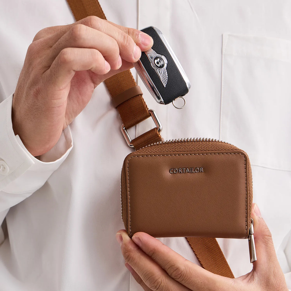 Orange CORTAILOR MagSafe Leather Wallet Stand attached to an iPhone case while a card is being pulled out in a cafe