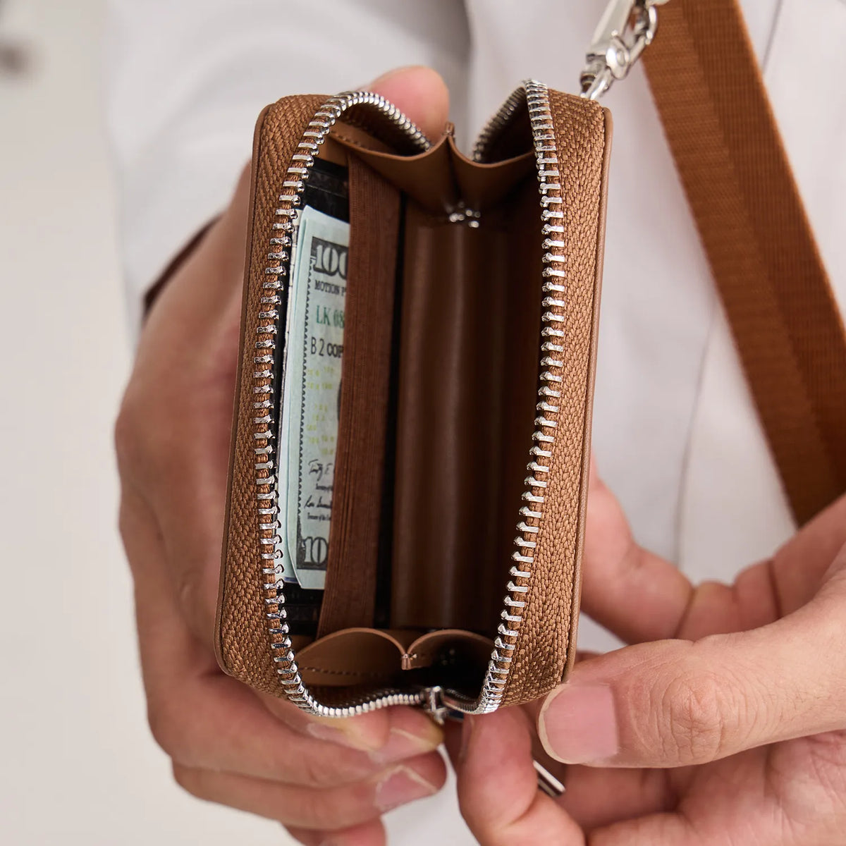 Orange CORTAILOR MagSafe Leather Wallet Stand holding an iPhone in stand mode on a desk