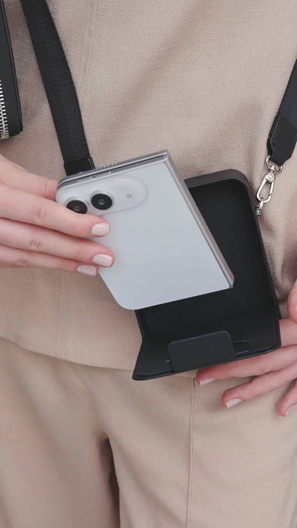 Orange CORTAILOR MagSafe Leather Wallet Stand being placed into a daily carry bag