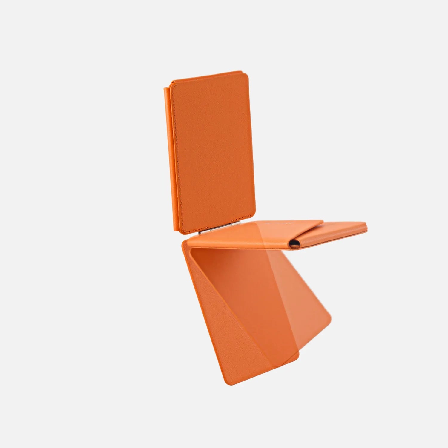 Orange CORTAILOR MagSafe Leather Wallet Stand holding an iPhone in stand mode on a desk